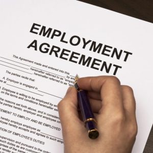 Female Hands Filling Out Employment Agreement Contract